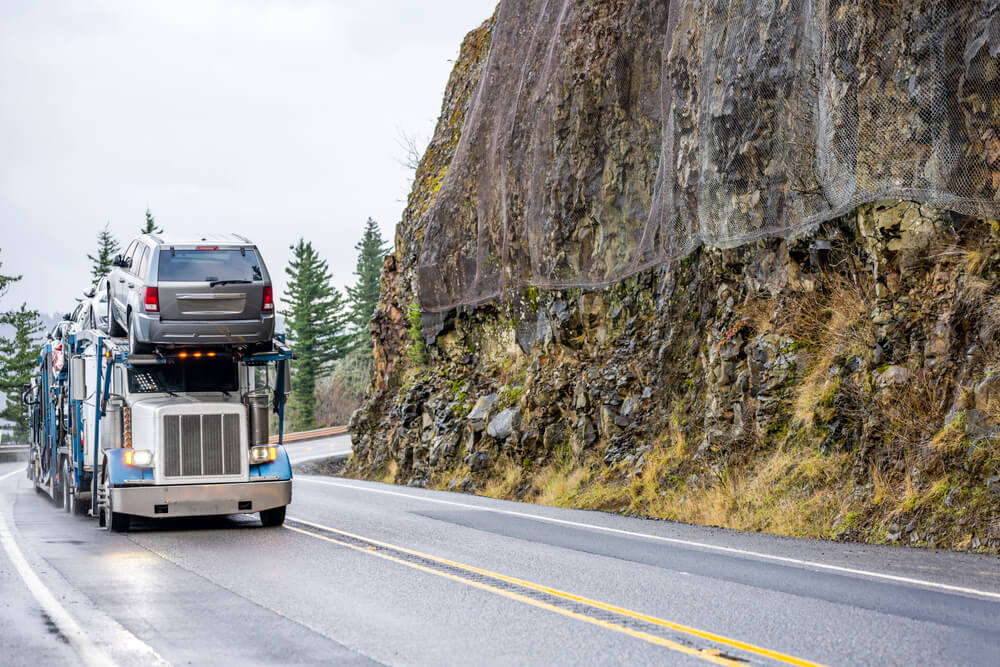 Truck Driving Down a Hilly Road